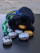 Photograph of the gold and silver stones spilling out of their matching bag.