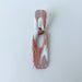A handmade rectangular drop earring with a cutout center, made from marbled polymer clay in shades of terracotta brown, shimmering copper, and white. The top and bottom segments are joined with antique copper-colored jump rings. The earrings have embedded titanium posts.