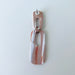 A handmade rectangular drop earring with a cutout center, made from marbled polymer clay in shades of terracotta brown, shimmering copper, and white. The top and bottom segments are joined with antique copper-colored jump rings. The earrings have embedded titanium posts.