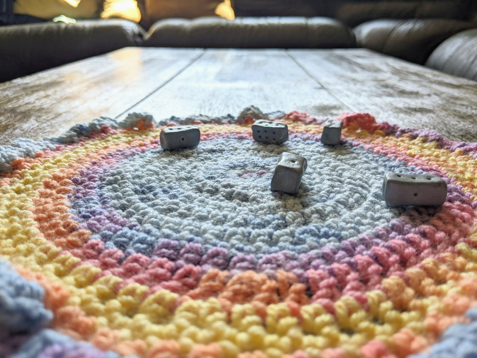 Close-up photograph of the altar cloth with the knucklebone dice on it.