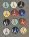 A gray background has twelve round shiny magnets with line drawings of the Eiffel Tower. They are in muted colors.