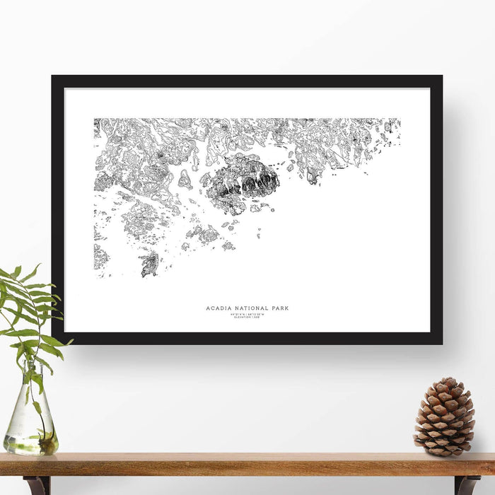 Map wall decor in a black frame. Contour lines of Acadia National Park are drawn on a white background. Text  below the map can be customized to create custom adventure art.