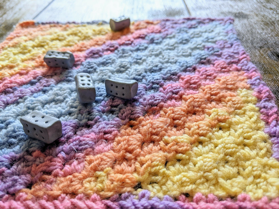 Photograph of the dice on the altar cloth, taken from a different angle.