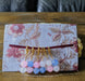 Photograph of a set of six beaded stitch markers inspired by the transgender flag.