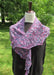 purple variegated variant of the tulip shawl on a black dress form