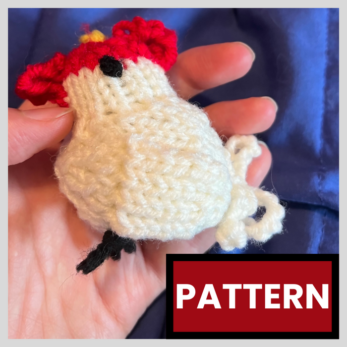 A photo of a knitted chicken toy, with the word "pattern" in all caps at the bottom. The chicken is white, with a red comb and wattle, a yellow beak, and black eyes and feet.