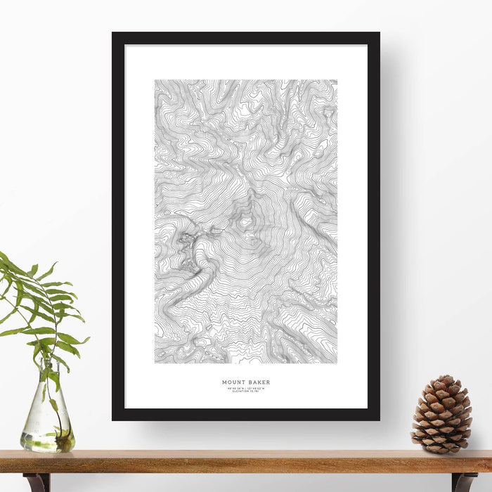 Mountain art print of Mount Baker with black and white topography in a black 24x36 vertical frame.