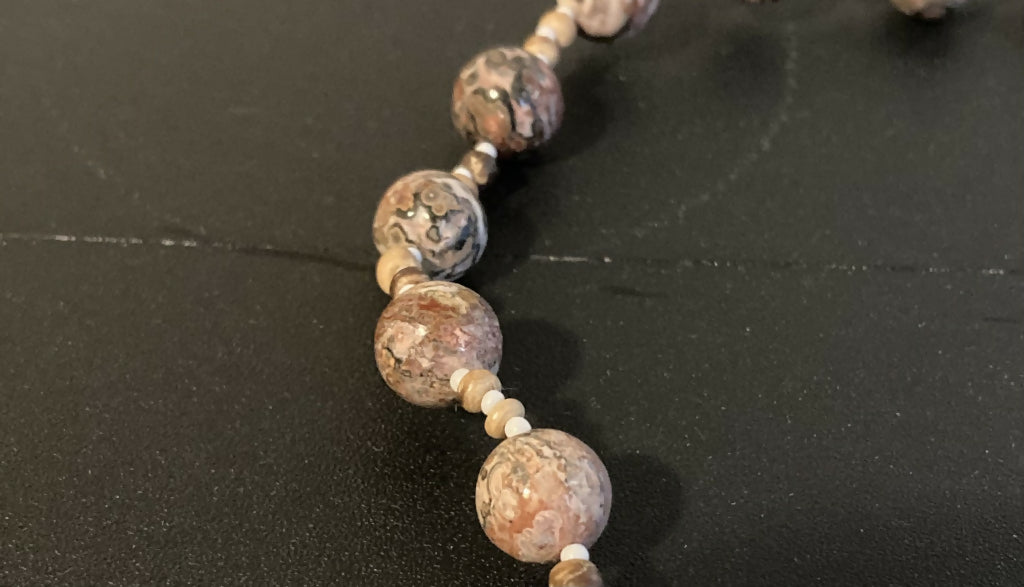 Close-up image of necklace showing the mottled pattern on the stone beads in detail.