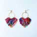 A pair of handmade fan-shaped polymer clay earrings displayed on a white background. The earrings feature gold-plated ball posts and hoops, with semi-transparent rainbow-colored clay and red etched fan-like lines. The marbling effect shows swirls of pink, blue, green, orange, and white.