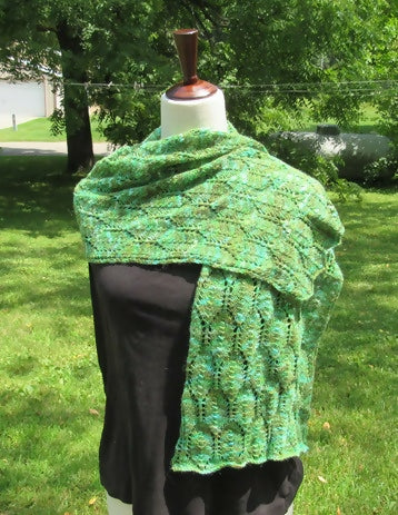 variegated wrap with a leaf motif on a dress form
