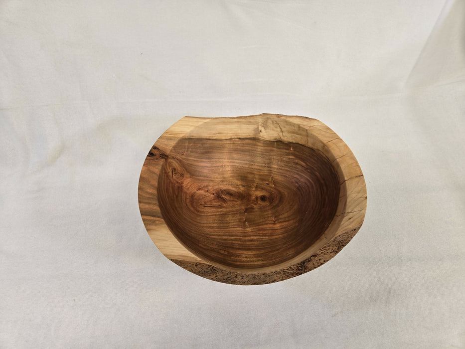 A distant picture of a natural edge wooden cherry bowl