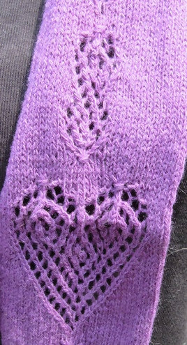 closeup of the heart motif on a purple scarf