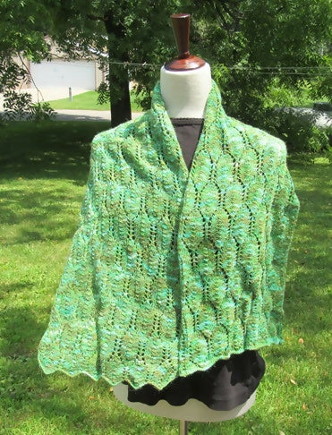 variegated wrap with a leaf motif on a dress form