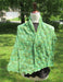 variegated wrap with a leaf motif on a dress form