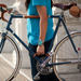 Person holding bike by leather handle installed between the down tube and seat tube