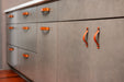 olive green kitchen cabinetry with tgilikum and Flanders honey leather handles