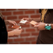 Two people exchanging business cards using a leather card case