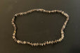 Necklace of alternating mussel shell chip beads and gold-colored glass seed beads.