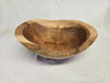 A close picture of a natural edge wooden cherry bowl