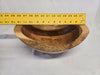 A picture of a wooden cherry bowl with a ruler on top measuring 12-1/2 inches